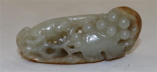 A Chinese celadon and russet jade squirrel and grape vine carving, 18th / 19th century, 6.8cm